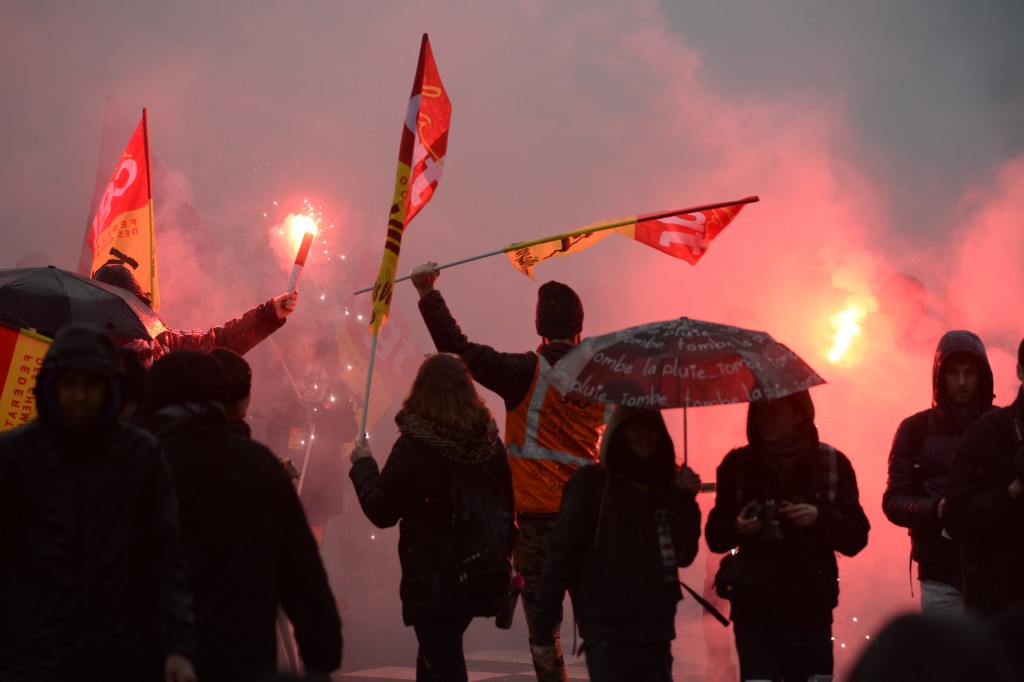 Protesters hold  flags of CGT French labour union CGT during a demonstration against labour law reforms in the French capital Paris on March 31, 2016. France faced fresh protests over labour reforms  just a day after the beleaguered government of President Francois Hollande was forced into an embarrassing U-turn over constitutional changes. AFP PHOTO / ALAIN JOCARD / AFP / ALAIN JOCARD
