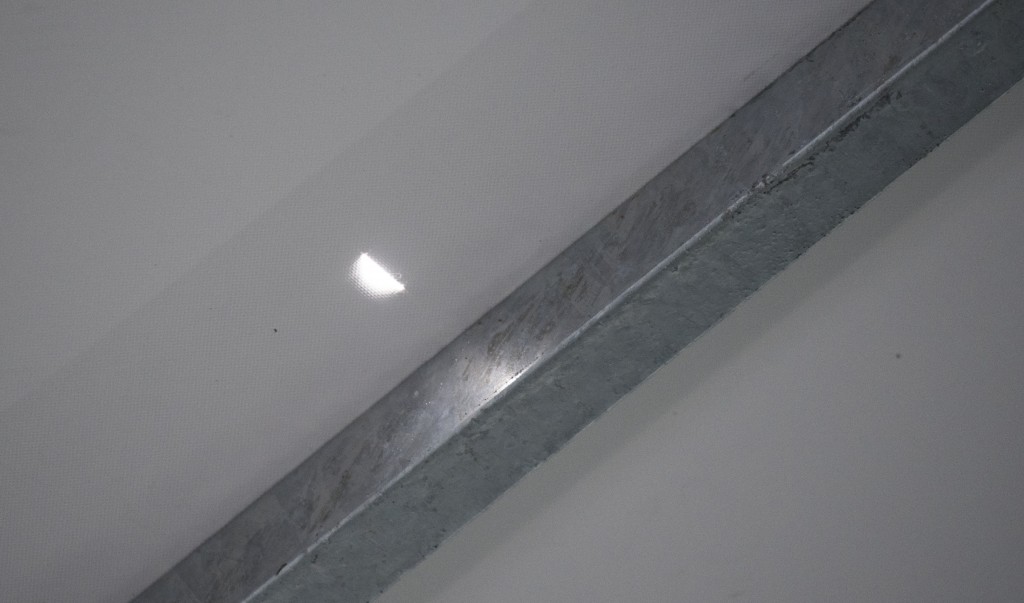 View of a hole made by a stray bullet in the press tent of the Olympic Equestrian Centre in Rio de Janeiro, Brazil on August 6, 2016.   The Equestrian competition is taking place in the so called Vila Militar, which houses most of Brazil's army training schools. / AFP PHOTO / John MACDOUGALL