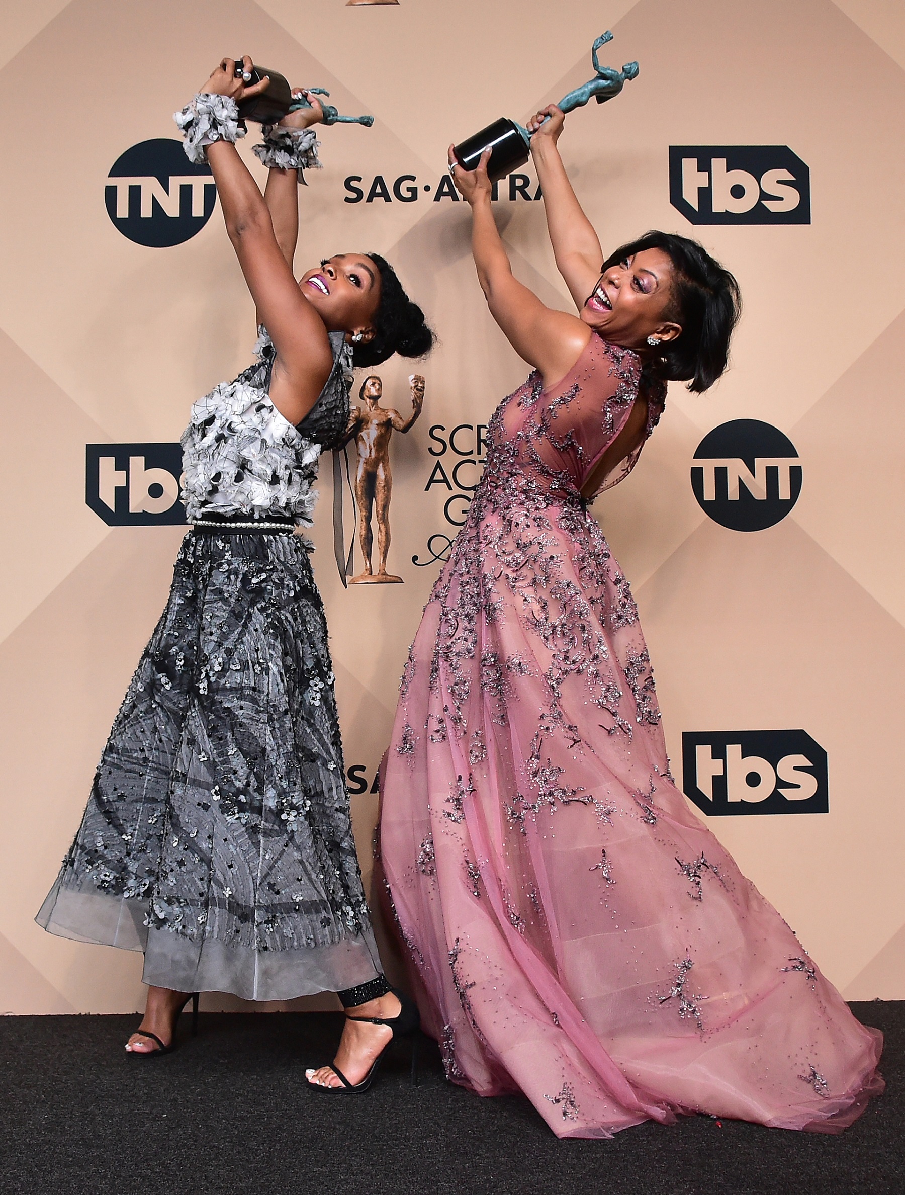 Actors Janelle Monae (L) and Taraji P. Henson, co-recipients of the Outstanding Performance by a Cast in a Motion Picture award for 'Hidden Figures,' pose in the press room during the 23rd Annual Screen Actors Guild Awards at the Shrine Exposition Center on January 29, 2017 in Los Angeles, California. / AFP PHOTO / FREDERIC J. BROWN